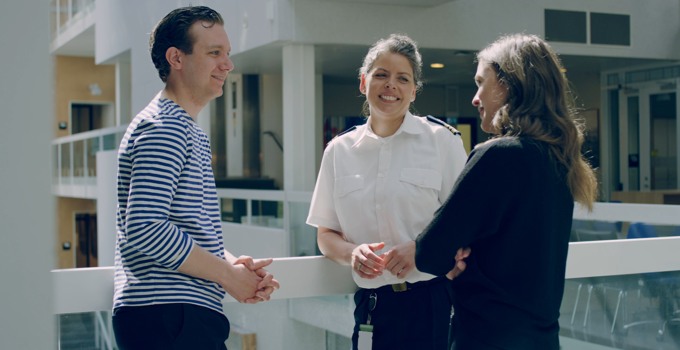 Civilian students  and Officerstudent talking on the campus.