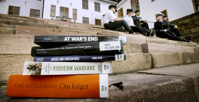 A stack of books sitting on the steps of a building.