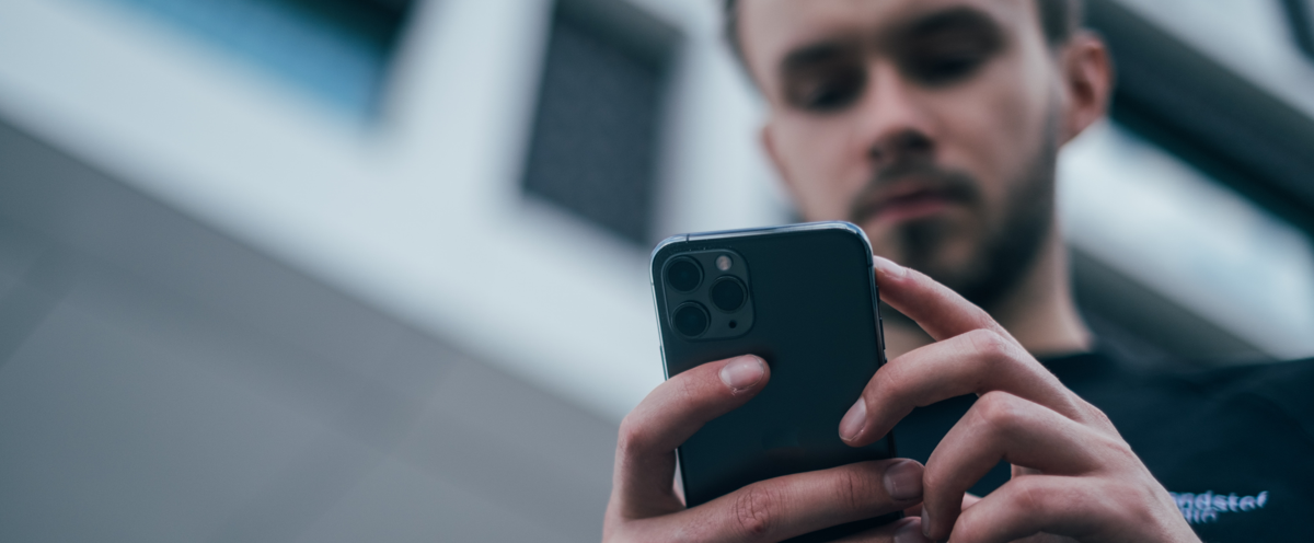 A man holding a cell phone in his hands.