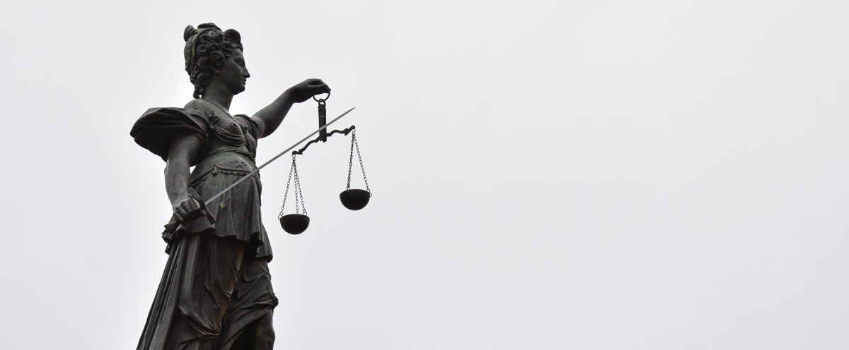 A statue of lady justice holding a scale of justice.
