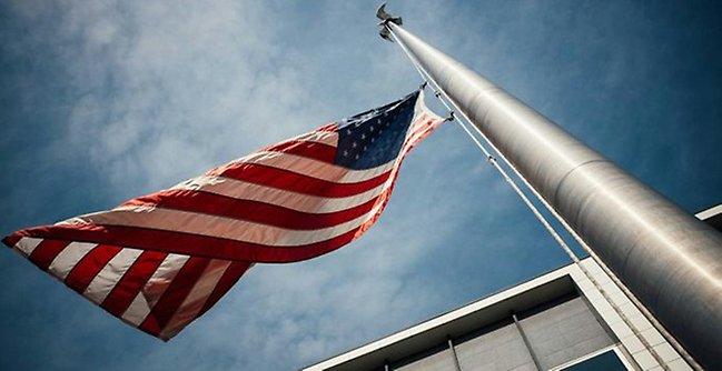 Amerikansk flagga mot en blå himmel.
